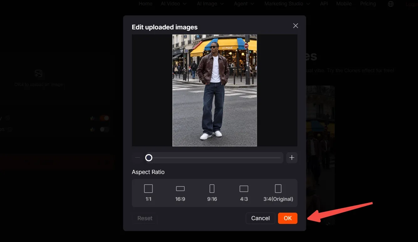 A person stands in front of a café, editing an uploaded image on a screen.