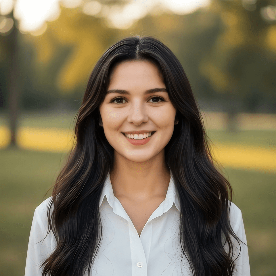 Golden hour warmth, gentle smile, serene park portrait.