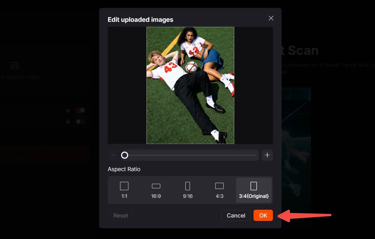 Two people lying on grass, one holding a soccer ball, editing an image on a screen.