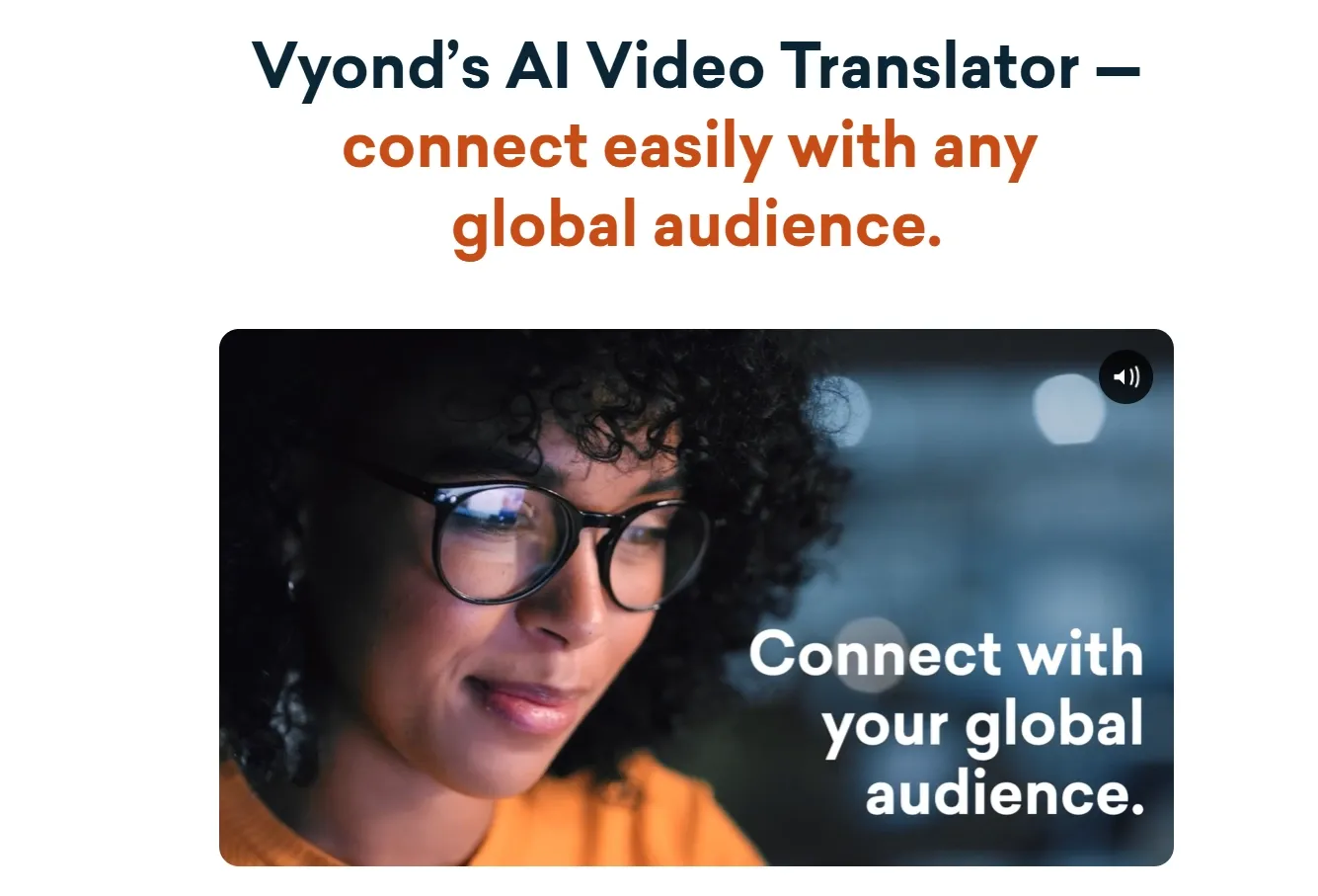 A woman with glasses smiles while using a video translation tool.