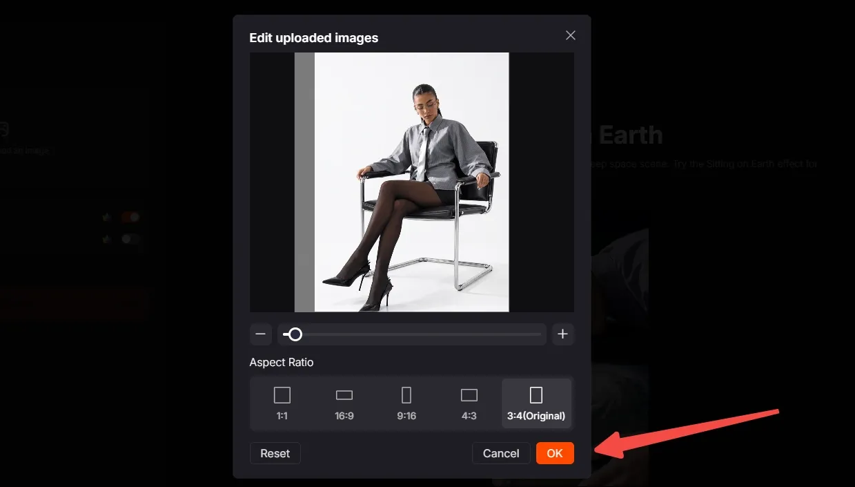 A woman in a gray outfit sits in a chair, editing an image on a screen.